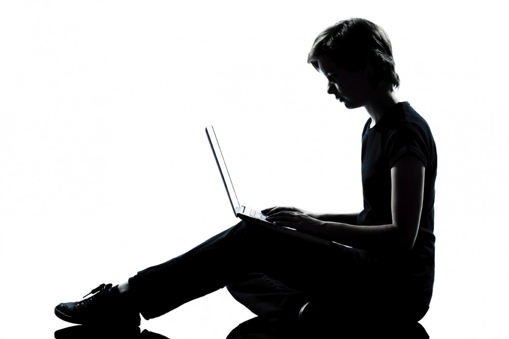 one young teenager boy or girl silhouette computer computing lap